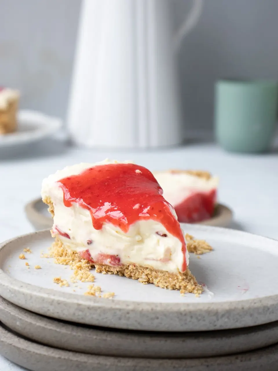 Slice of no-bake strawberry cheesecake with glossy strawberry topping